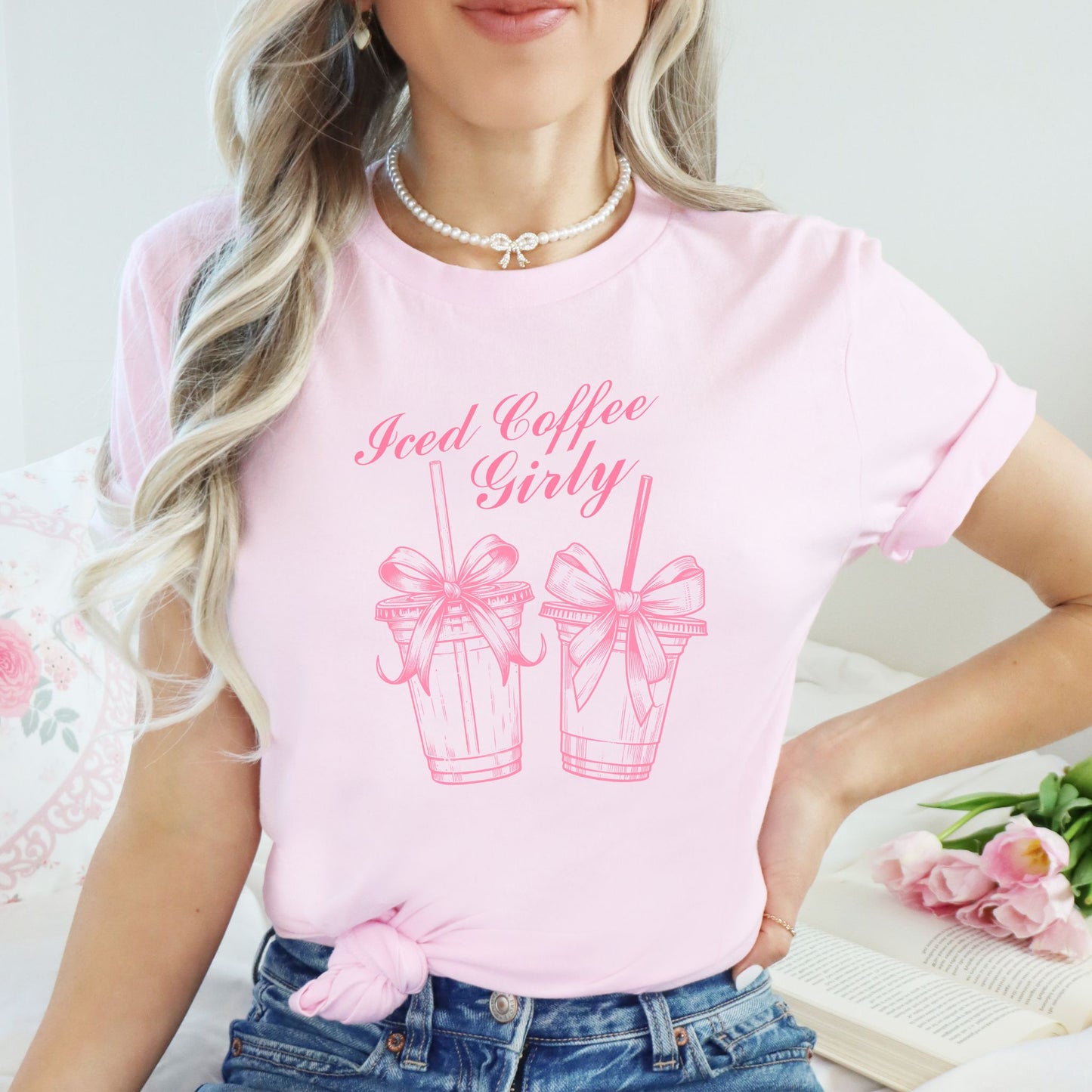Person wearing a pink t-shirt with 'Iced Coffee Girly' design and text.