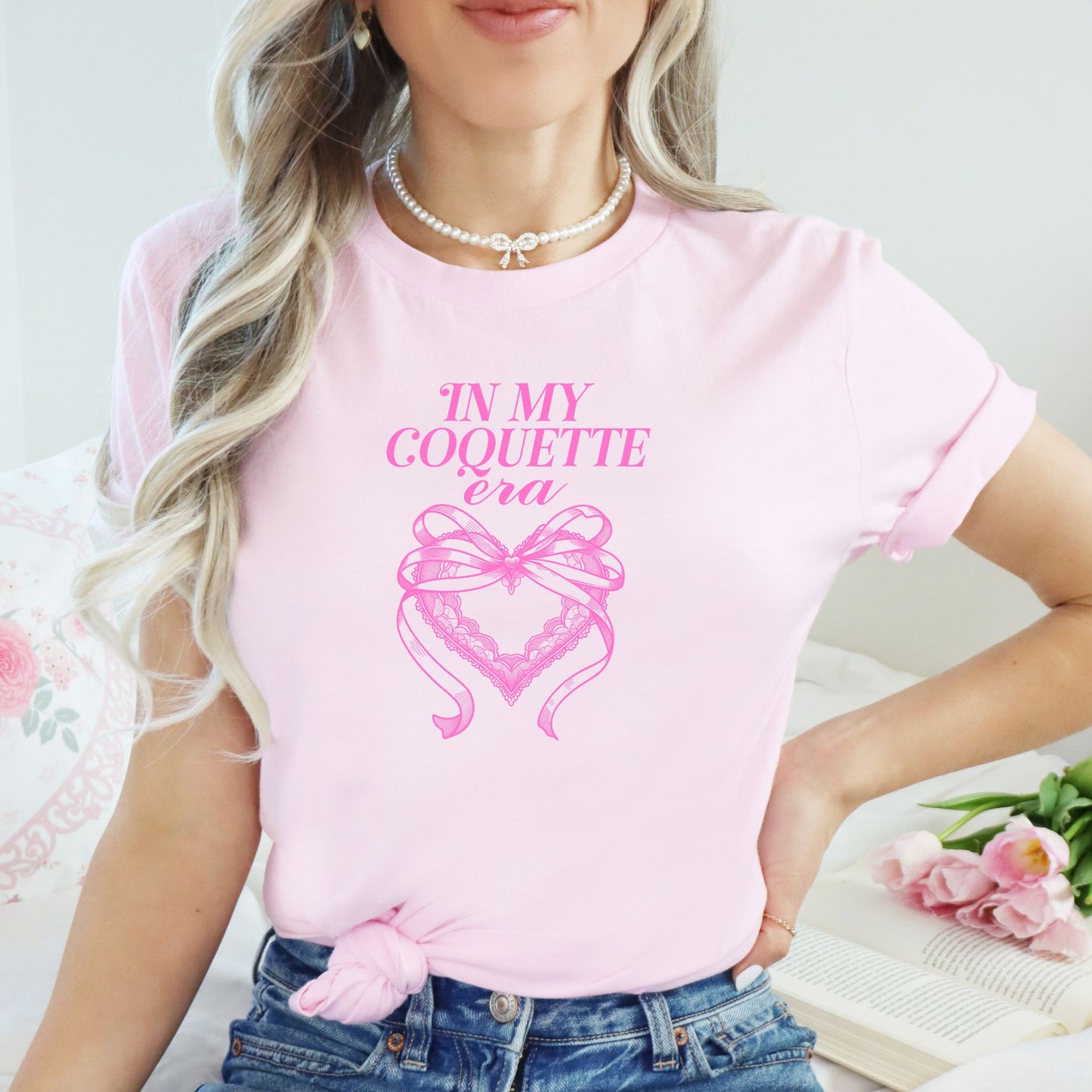 In My Coquette Era 100% cotton pink t-shirt model with bow and heart design in pink print