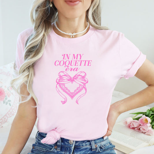 In My Coquette Era 100% cotton pink t-shirt model with bow and heart design in pink print