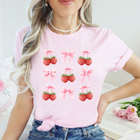 Pink t-shirt with strawberry and bow graphics for coquette aesthetic fashion